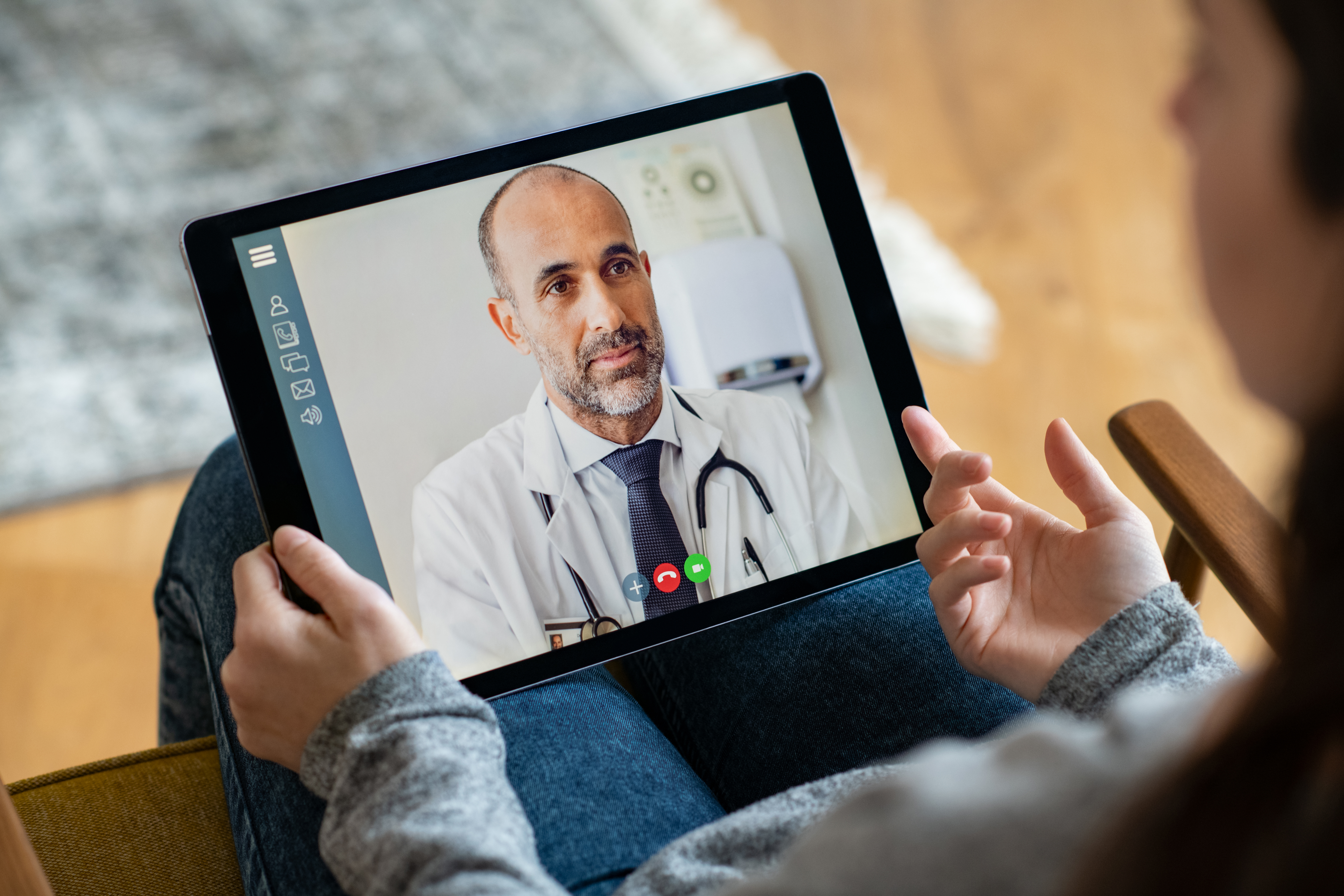 a patient having a video consultation with their doctor on a tablet